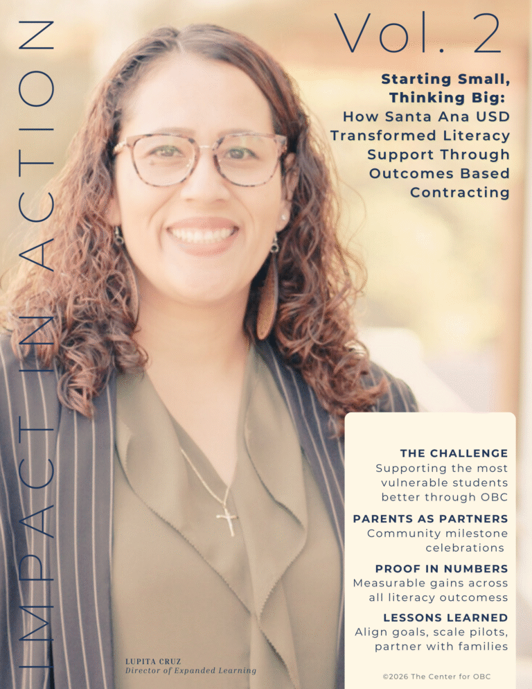 Woman in business attire and glasses smiling