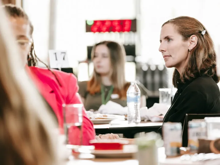 Professional woman listening at conference.
